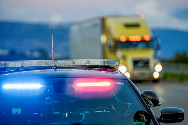 Law enforcement inspecting commercial vehicle credentials